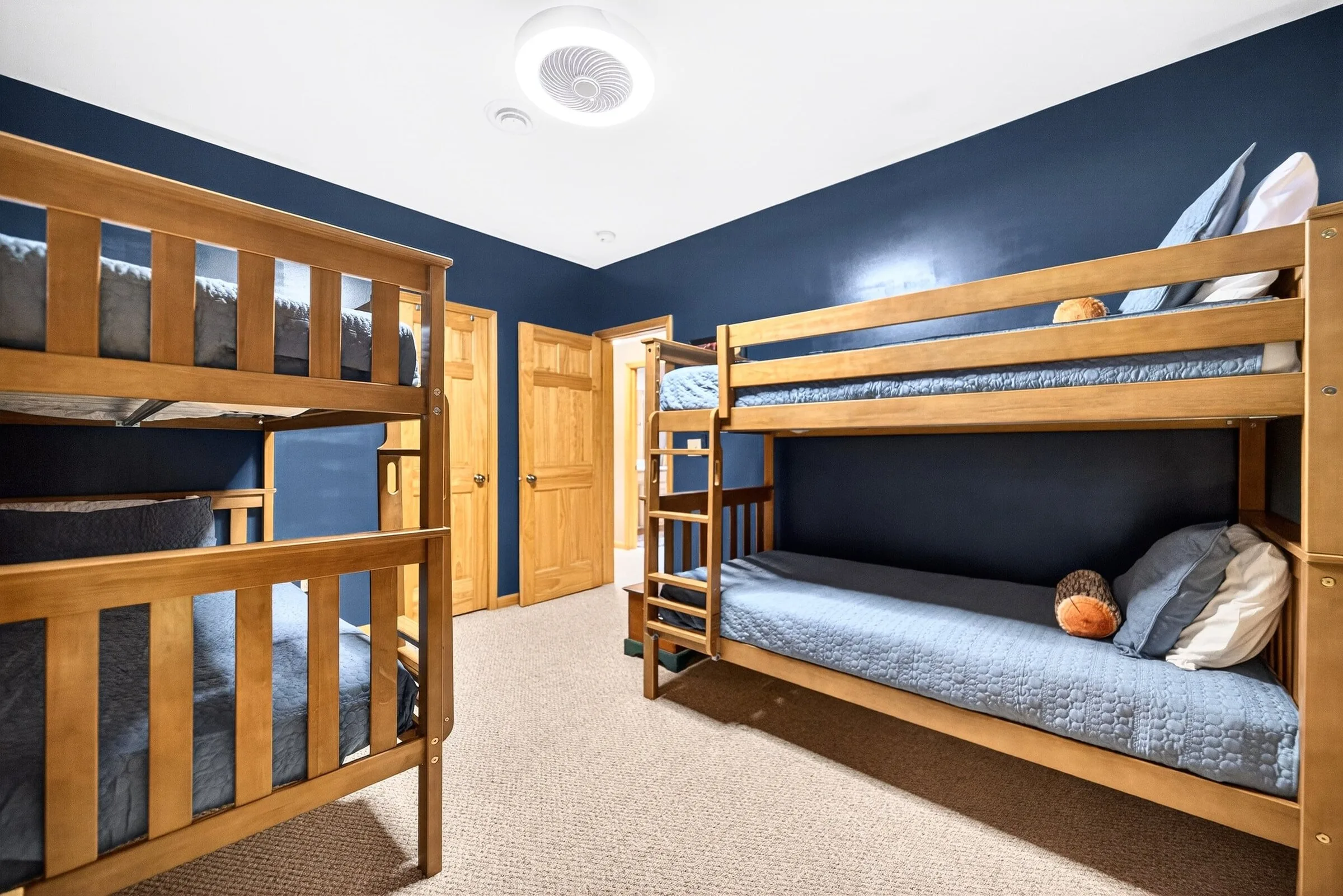 The bunk room from the doorway, two bunk sets and four twin beds