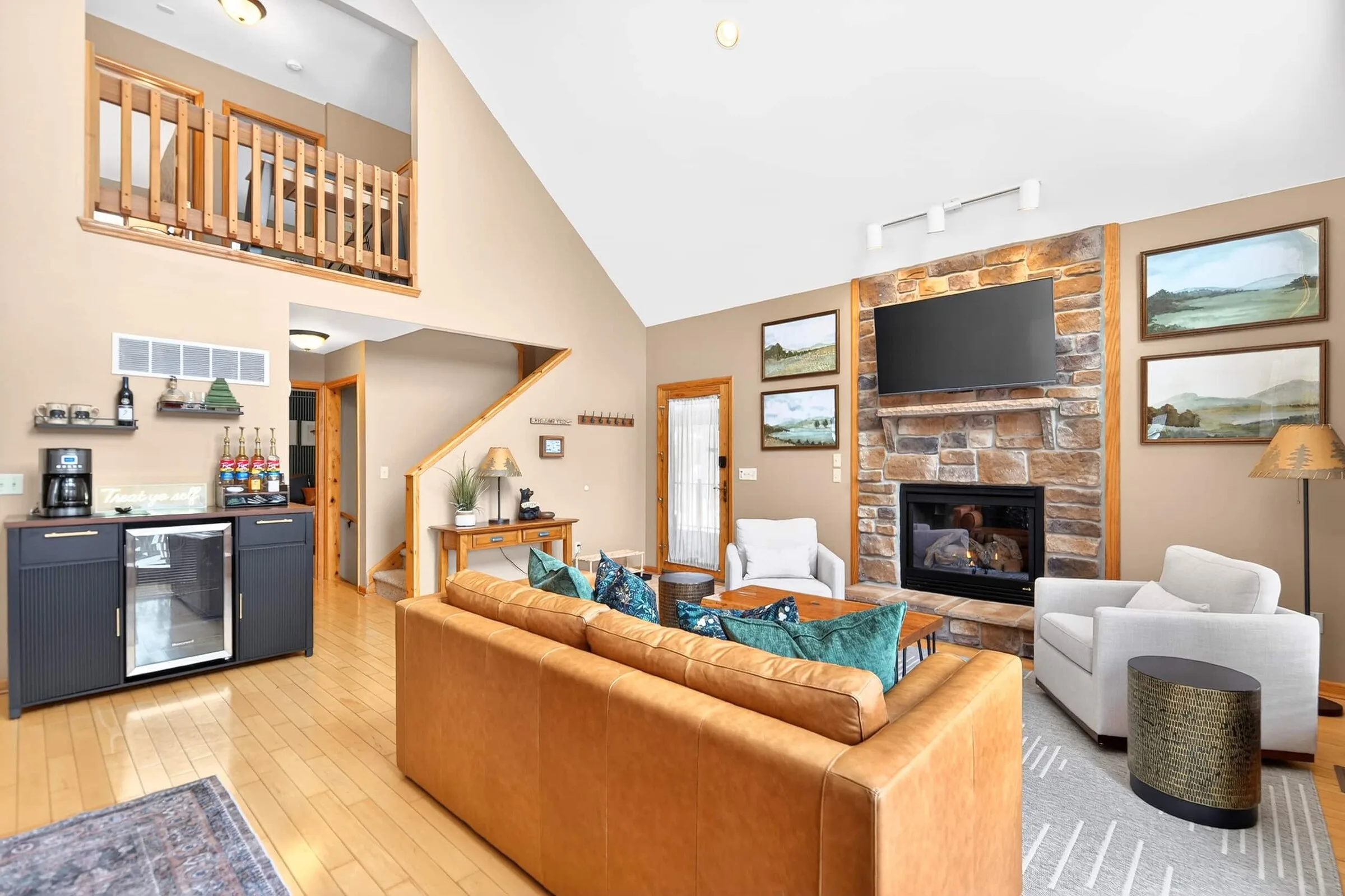 The great room sleeper sofa, with the kitchen and loft behind it