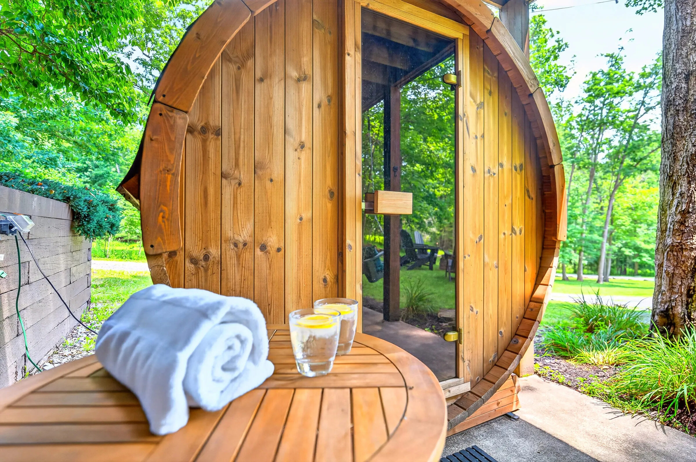 The cedar barrel sauna with towels and cold drinks set out