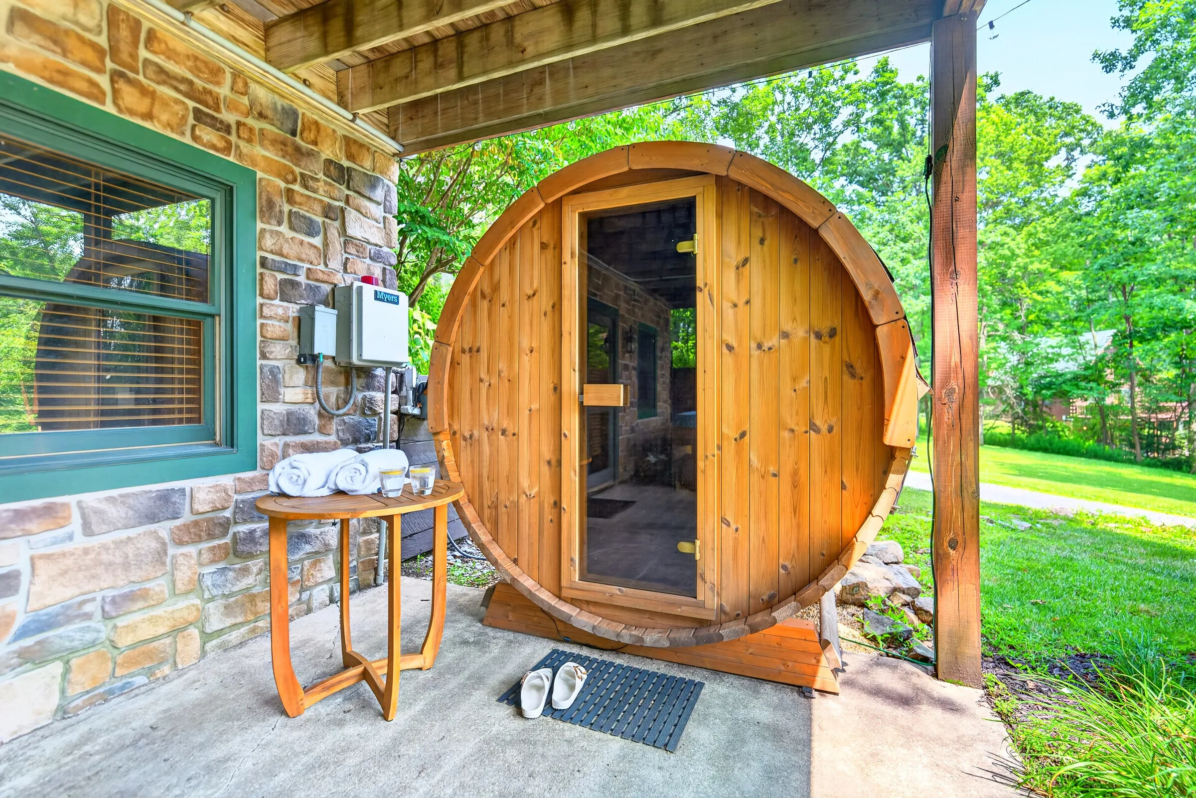 The cedar barrel sauna with towels laid out beside it